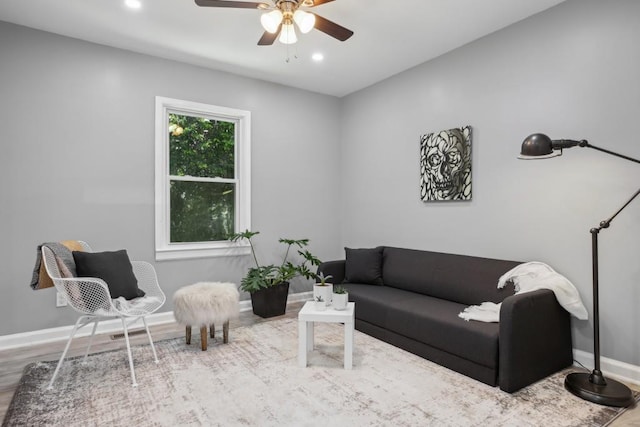 living room featuring ceiling fan and hardwood / wood-style flooring