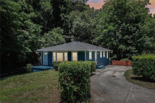 property exterior at dusk with a yard