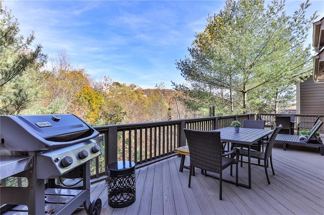 wooden deck featuring a grill