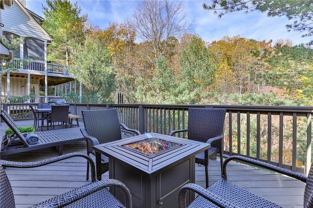 wooden terrace with an outdoor fire pit