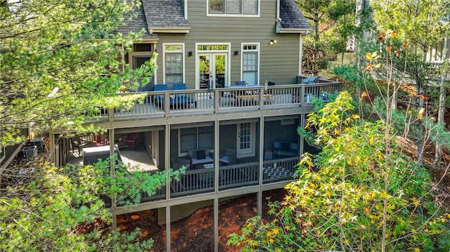 rear view of house with a sunroom and a deck