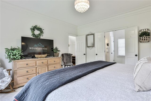 bedroom featuring a chandelier, carpet floors, and ornamental molding