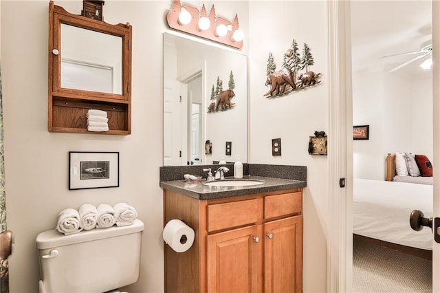 bathroom featuring vanity, ceiling fan, and toilet