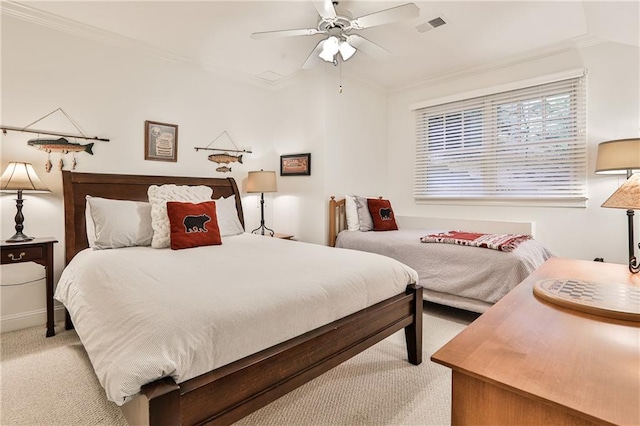 carpeted bedroom featuring ceiling fan and ornamental molding