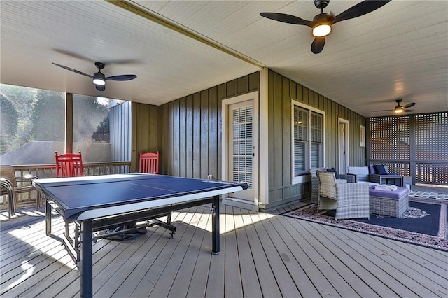 wooden deck featuring an outdoor living space and ceiling fan