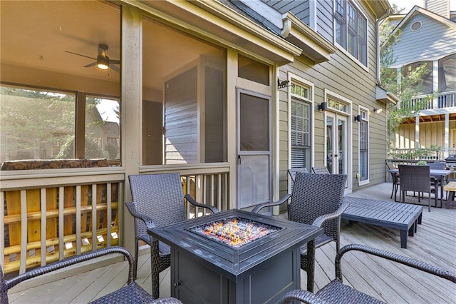 wooden terrace featuring an outdoor fire pit and ceiling fan