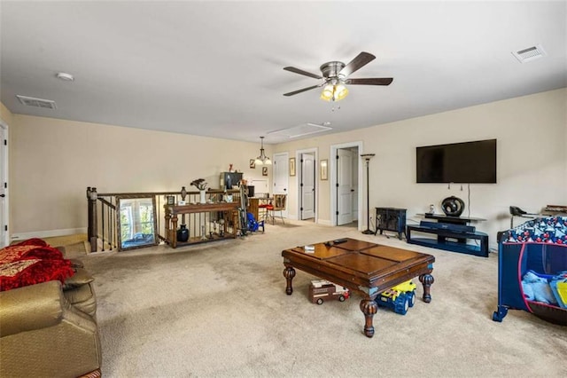 living room featuring ceiling fan and carpet