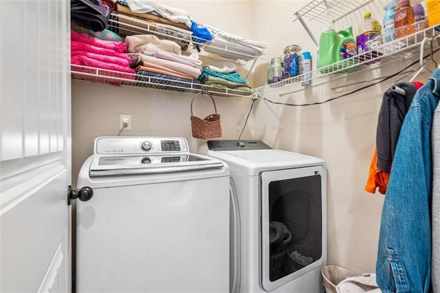 clothes washing area featuring independent washer and dryer