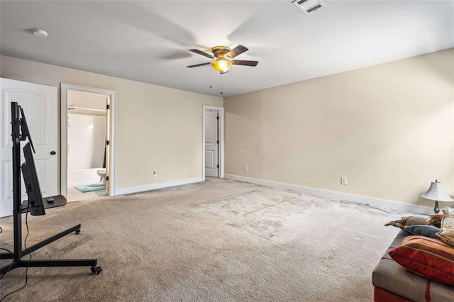 carpeted bedroom with ensuite bath and ceiling fan