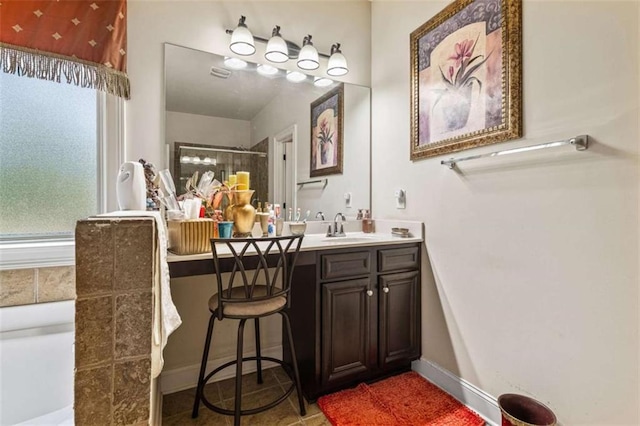 bathroom with an enclosed shower, vanity, and tile patterned floors