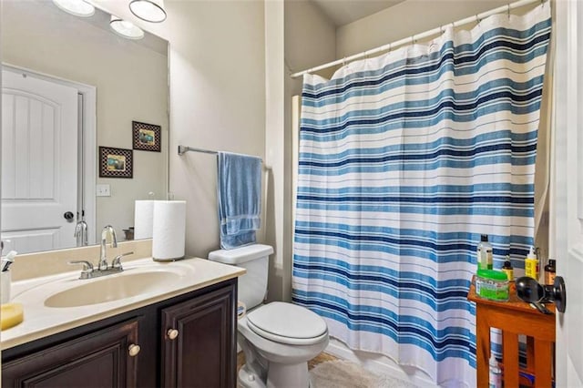 bathroom featuring vanity, toilet, and a shower with shower curtain