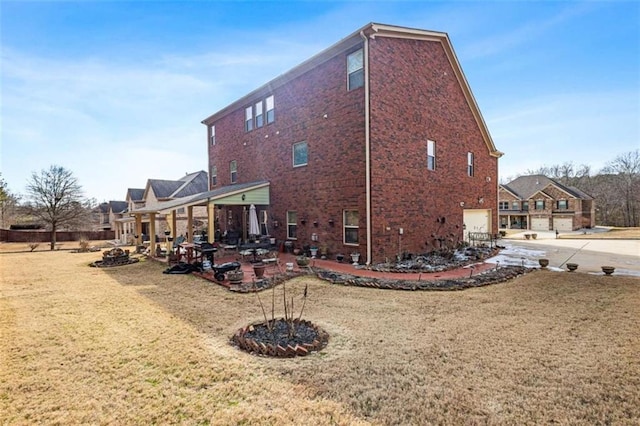 view of property exterior featuring a garage, a yard, and a patio area