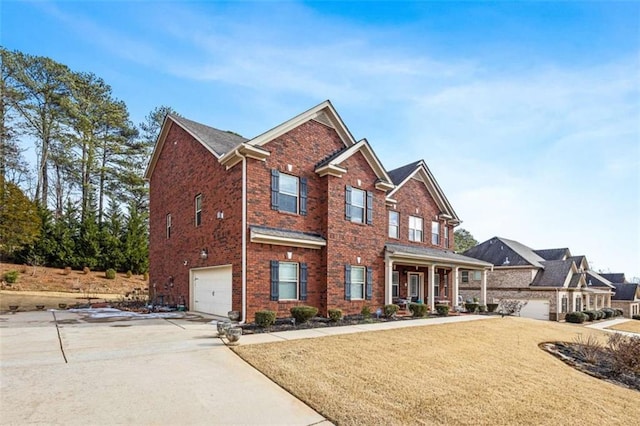 craftsman-style house featuring a garage, a front yard, and covered porch