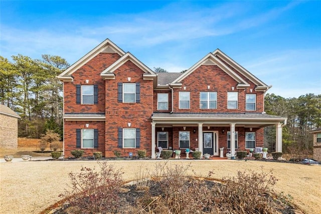 craftsman-style home with a front yard and covered porch