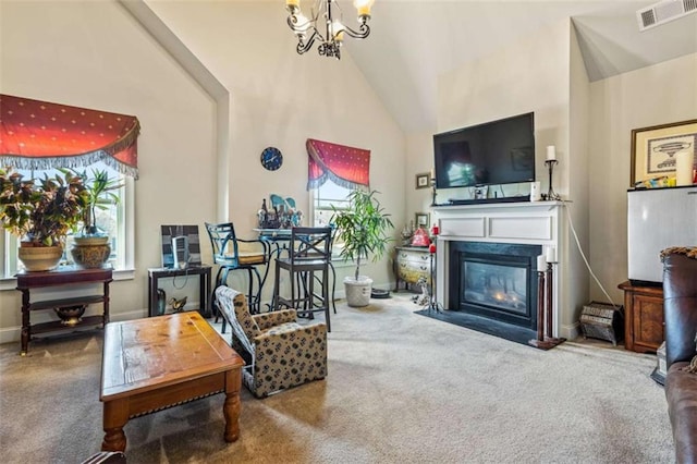 living room with carpet flooring, a chandelier, and high vaulted ceiling