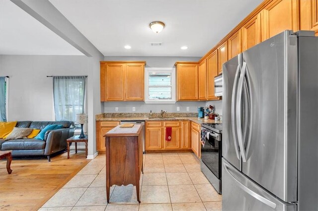 898 Allene Ave SW, Atlanta, GA 30310 - kitchen with light wood finished floors, a ceiling fan, open floor plan, stainless steel dishwasher, and visible vents