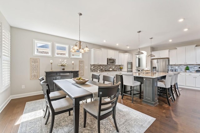 dining room featuring recessed lighting, dark wood-style flooring, baseboards, and a chandelier