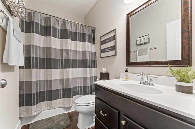 bathroom featuring vanity, wood finished floors, and toilet