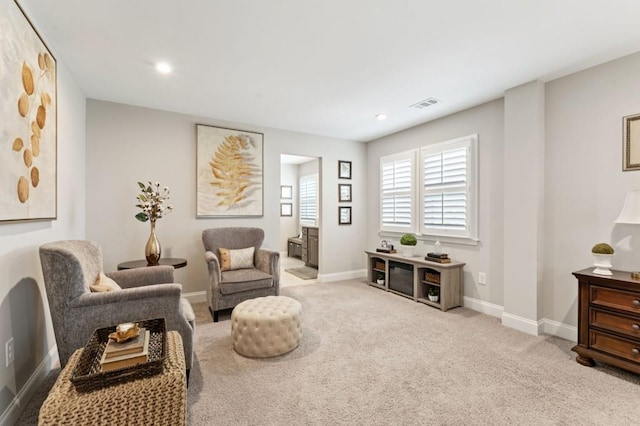 sitting room featuring baseboards, carpet, and recessed lighting