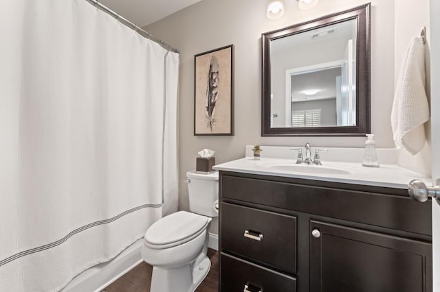 bathroom featuring toilet, vanity, wood finished floors, and a shower with shower curtain