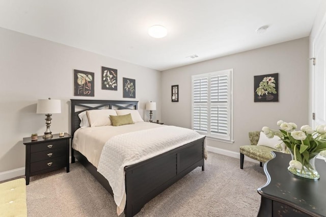 bedroom featuring baseboards and light colored carpet