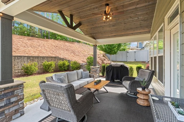 view of patio with an outdoor living space, a fenced backyard, a grill, a ceiling fan, and a gate