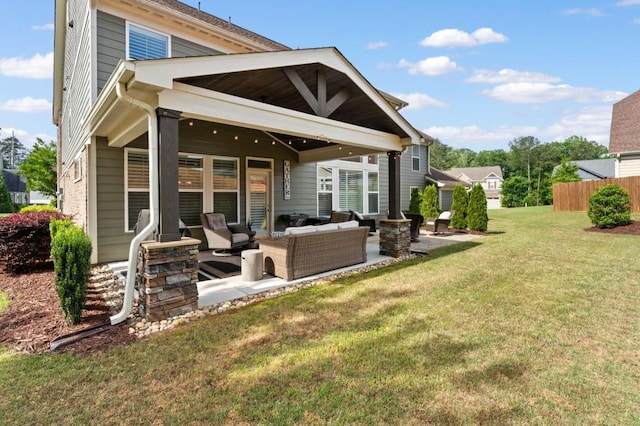 rear view of property with an outdoor living space and a patio area