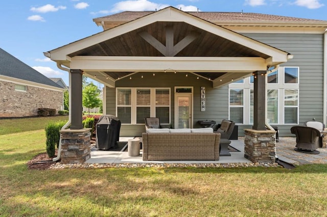 back of property featuring outdoor lounge area, a patio area, and a yard