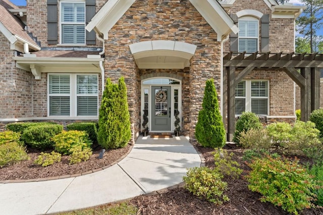 property entrance with stone siding and brick siding