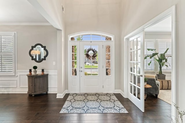 entrance foyer featuring hardwood / wood-style flooring and crown molding