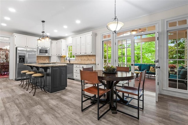 121 Clipper Bay Dr, Alpharetta, GA 30005 - kitchen with appliances with stainless steel finishes, a center island, white cabinets, crown molding, and backsplash