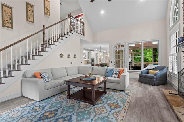 121 Clipper Bay Dr, Alpharetta, GA 30005 - living area featuring high vaulted ceiling, wood finished floors, stairway, and a chandelier