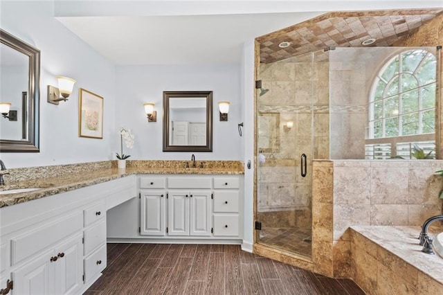 121 Clipper Bay Dr, Alpharetta, GA 30005 - full bathroom featuring double vanity, a garden tub, a stall shower, and wood finished floors
