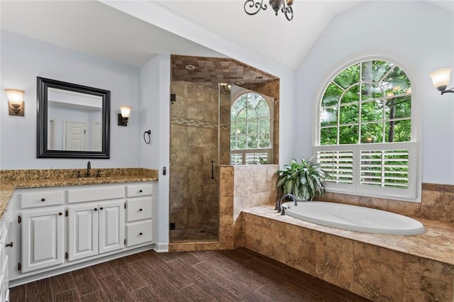 121 Clipper Bay Dr, Alpharetta, GA 30005 - full bathroom with healthy amount of natural light, a bath, vanity, a shower stall, and lofted ceiling