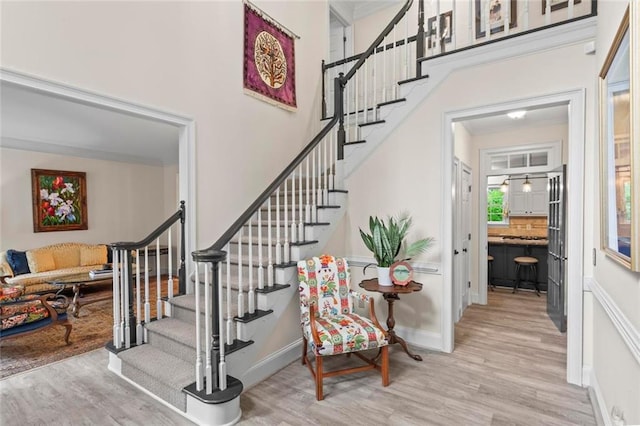 121 Clipper Bay Dr, Alpharetta, GA 30005 - staircase with wood finished floors, crown molding, and a high ceiling