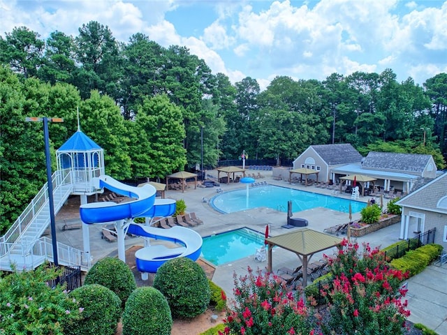 121 Clipper Bay Dr, Alpharetta, GA 30005 - community pool featuring a water slide, a storage structure, a patio, and an outbuilding