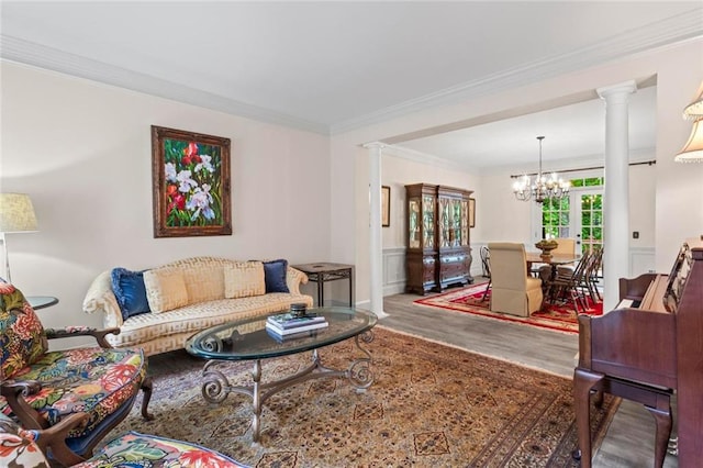 121 Clipper Bay Dr, Alpharetta, GA 30005 - living area with wood finished floors, a chandelier, ornate columns, and ornamental molding