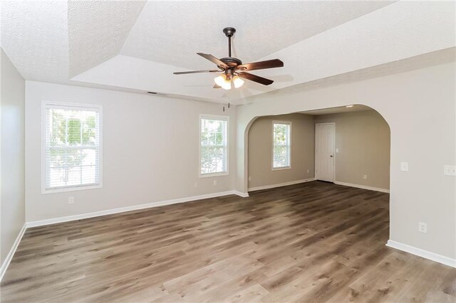 spare room featuring hardwood / wood-style flooring, plenty of natural light, and ceiling fan