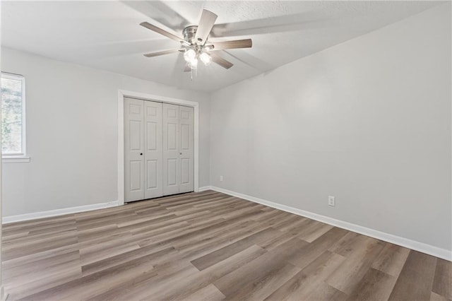 unfurnished bedroom featuring a closet, ceiling fan, and light hardwood / wood-style floors