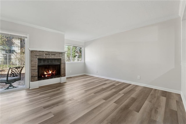 unfurnished living room featuring a fireplace, light wood-type flooring, and ornamental molding