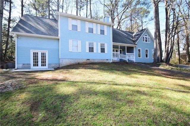 rear view of house featuring a porch, a yard, a chimney, french doors, and crawl space