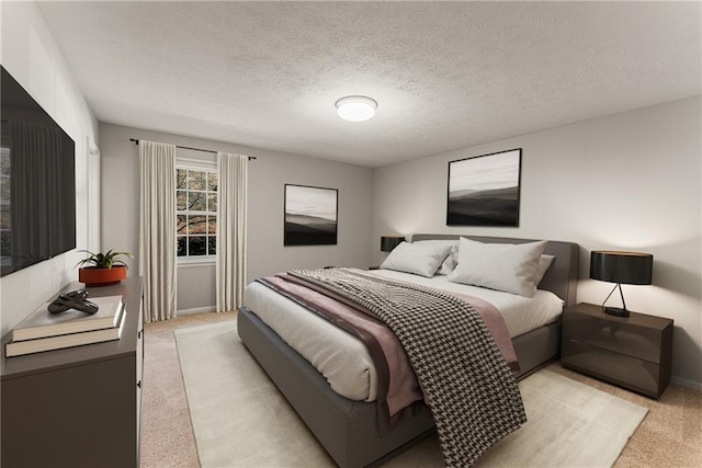 bedroom featuring light carpet and a textured ceiling