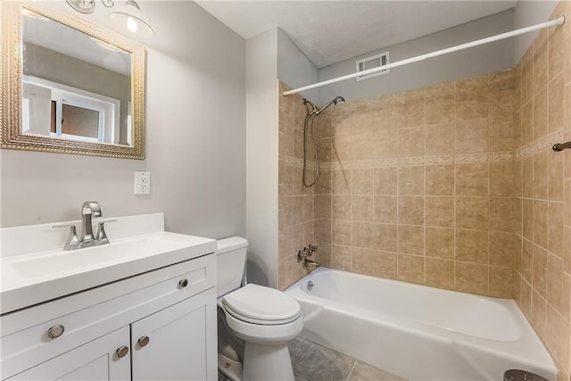 bathroom with visible vents, toilet, tile patterned floors, tub / shower combination, and vanity