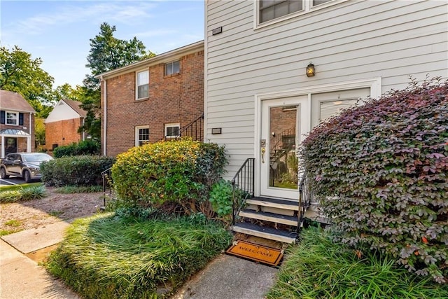 doorway to property with brick siding