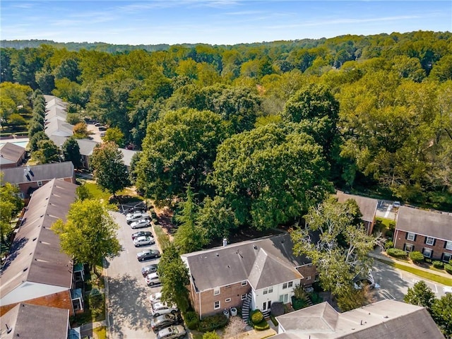 birds eye view of property featuring a wooded view