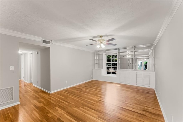 unfurnished living room with a textured ceiling, ornamental molding, visible vents, and light wood-style floors