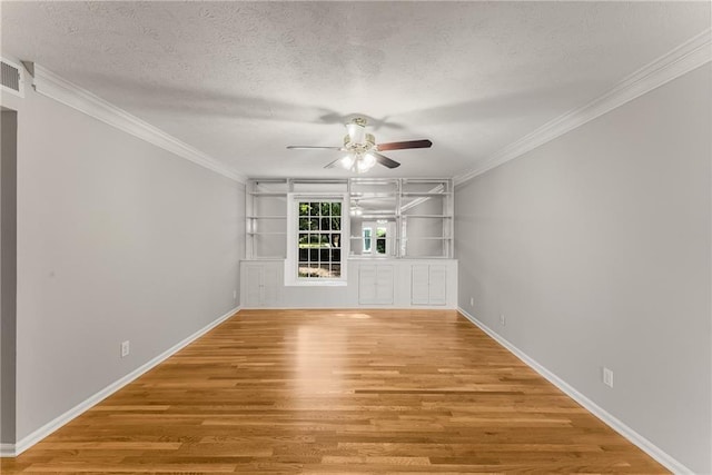 unfurnished living room featuring ceiling fan, crown molding, a textured ceiling, and wood finished floors