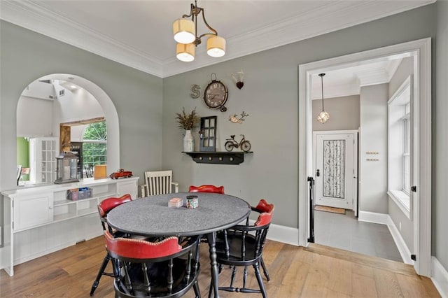 4337 Mountain View Rd, Oakwood, GA 30566 - dining space featuring arched walkways, crown molding, wood-type flooring, and a chandelier