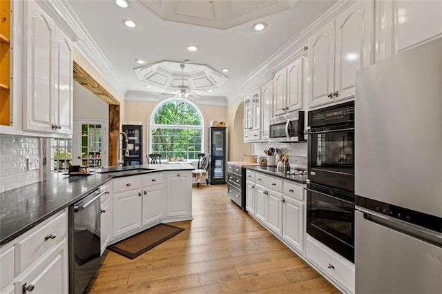 4337 Mountain View Rd, Oakwood, GA 30566 - kitchen with stainless steel appliances, white cabinetry, tasteful backsplash, light wood-type flooring, and a peninsula
