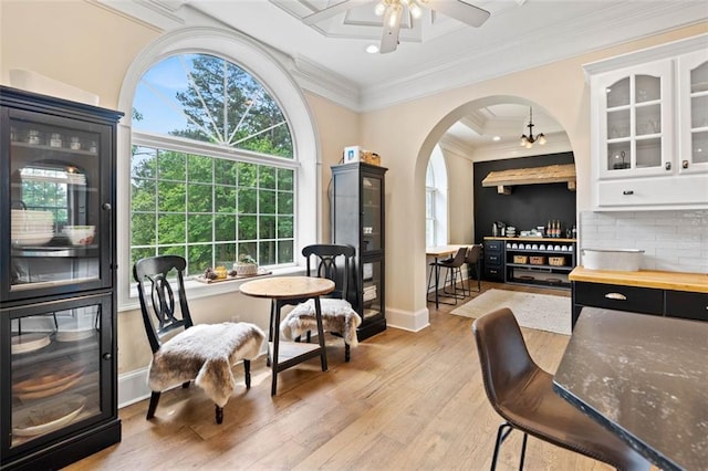 4337 Mountain View Rd, Oakwood, GA 30566 - dining area featuring light wood finished floors, a ceiling fan, ornamental molding, and arched walkways